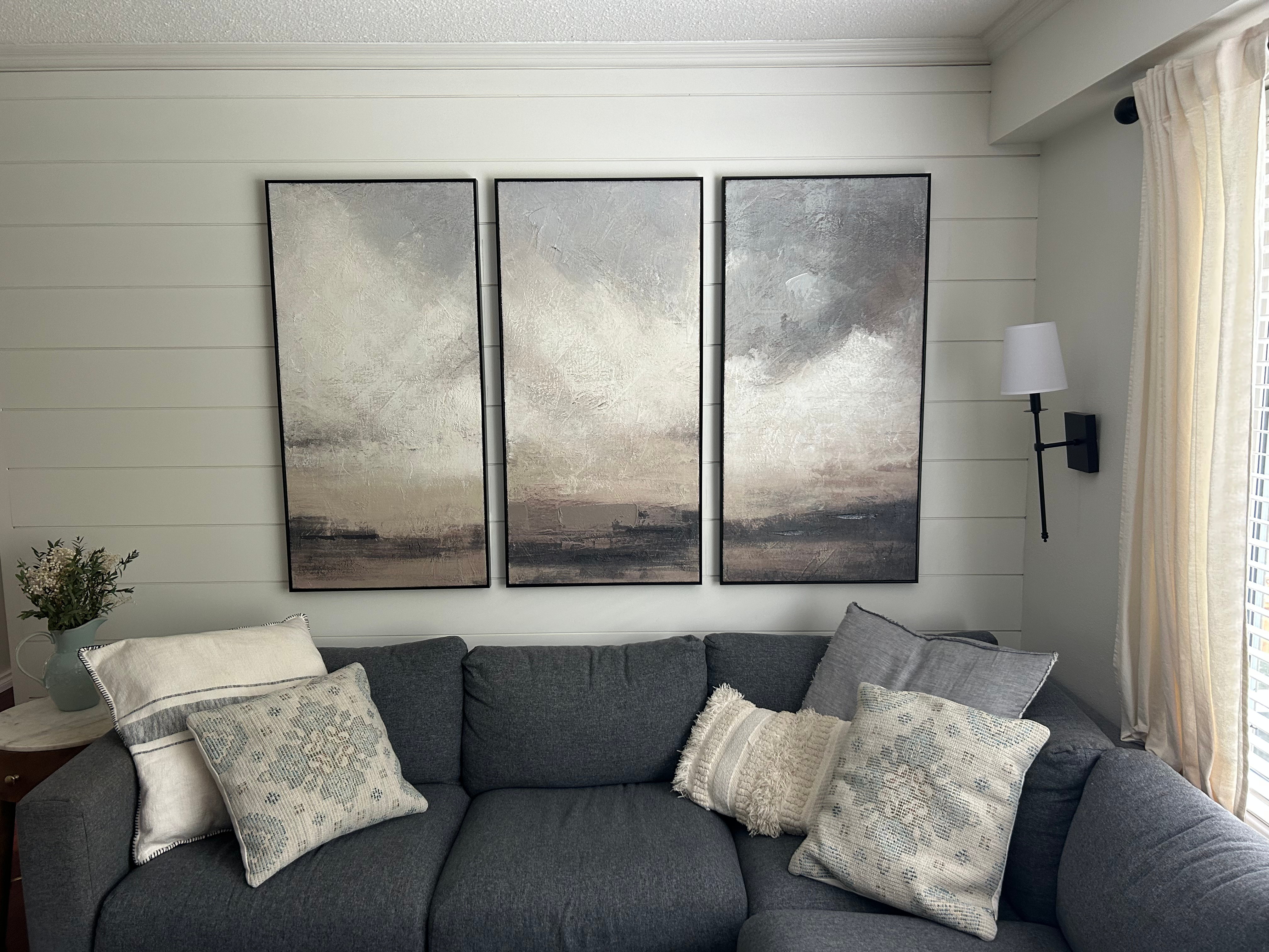 Wall art hanging in a styled living room