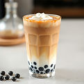 boba brown sugar milk tea with black pearl boba at the bottom and the white cream.jpg