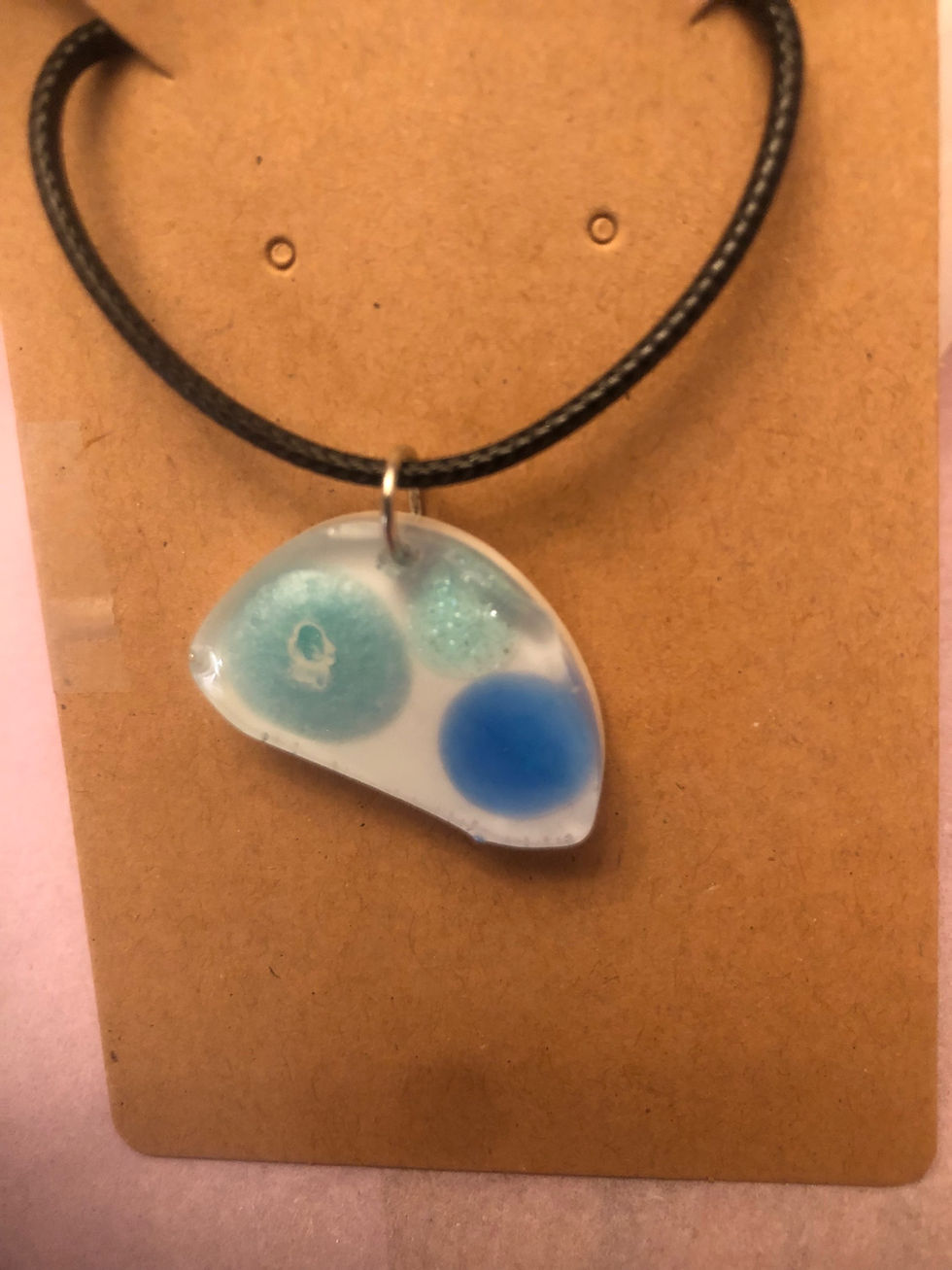 Thumbnail: Multi-blue ovoid necklace on a black cord