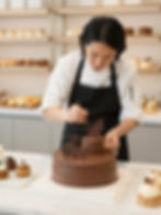 Pastry chef decorating a chocolate cake