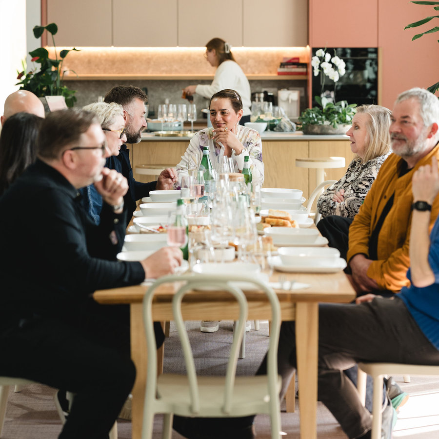 Sara at the table with architects at an A Cena dinner