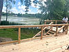A newly built deck overlooking a small lake.