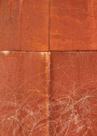 Abstract orange square pattern with folds and scratches on the surface.