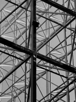 Geometric metal structure in black and white against the sky background.