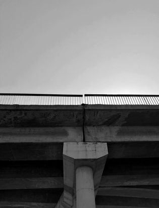 Black and white bridge, sky background, concrete pillar.