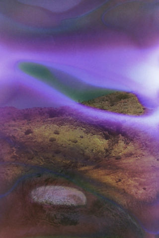 A vibrant purple and green photograph depicting a majestic mountain landscape.