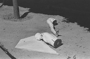 Black and white photo with two white mannequins parts.