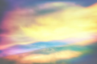 Abstract image with a soft blend of pastel colors. Yellow, pink, blue, and green hues swirl together, creating a dreamy, serene atmosphere.