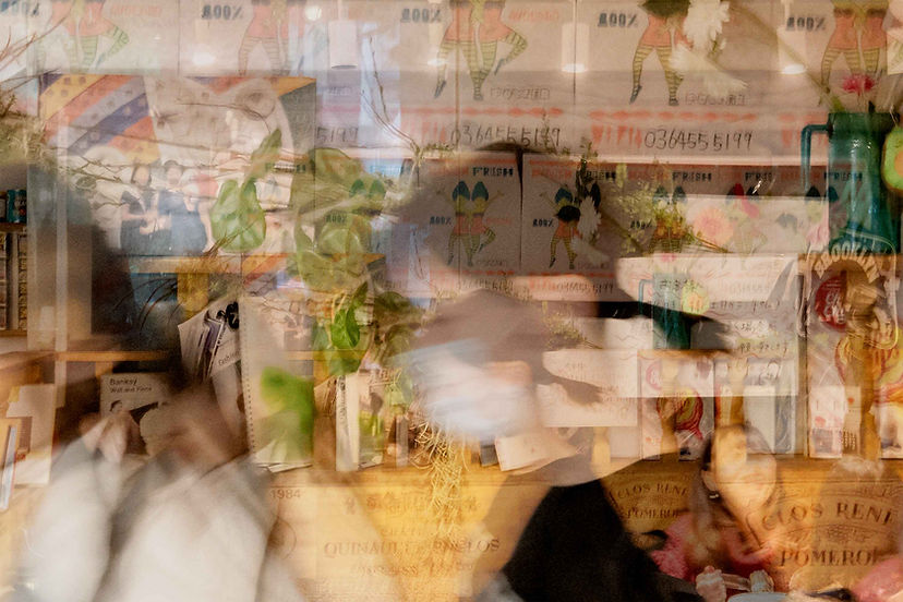 Blurred image of shop with text and multiple layers.