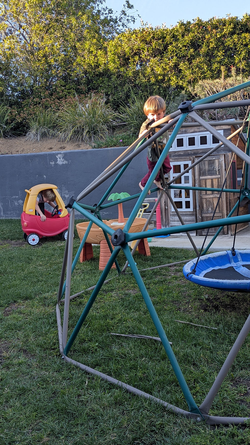 Played outside today...Brody trying to fit in the tiny car and Logan climbing on the jungle gym