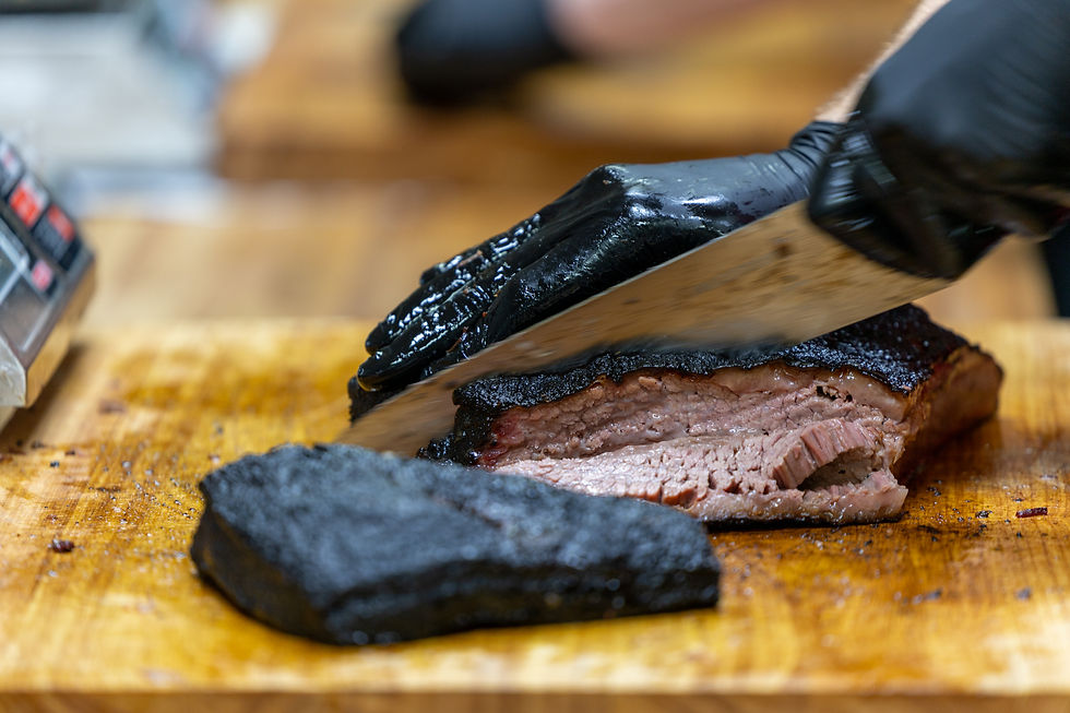 Slicing brisket at CorkScrew BBQ in Spring, Texas, where execution is never left to chance.