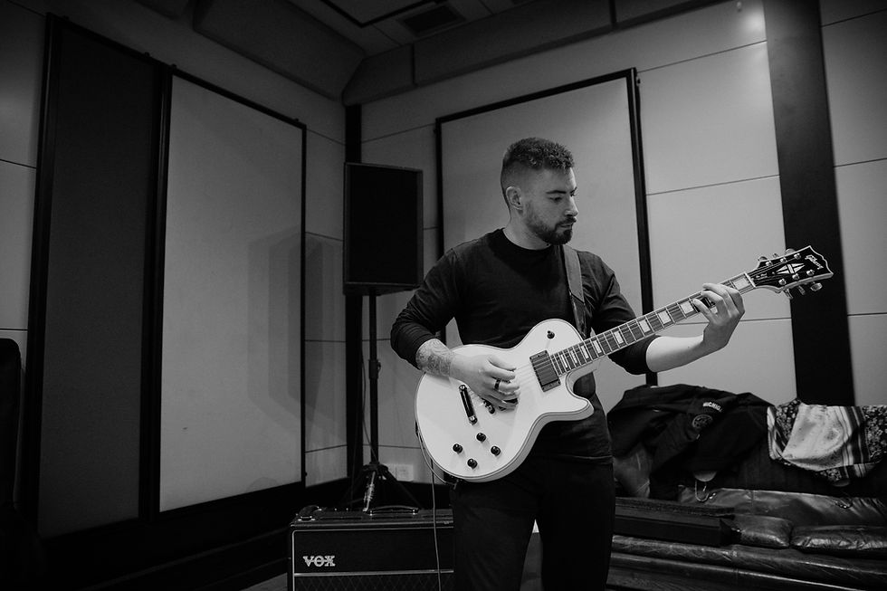 Adam Ward is a session guitarist performing on a white gibson les paul in a rehearsal studio in London.