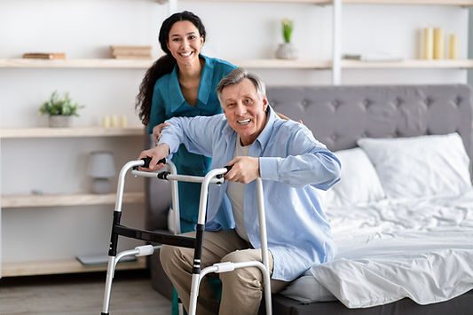 female-nurse-helping-elderly-male-with-walking-fra-VB48DHX.jpg