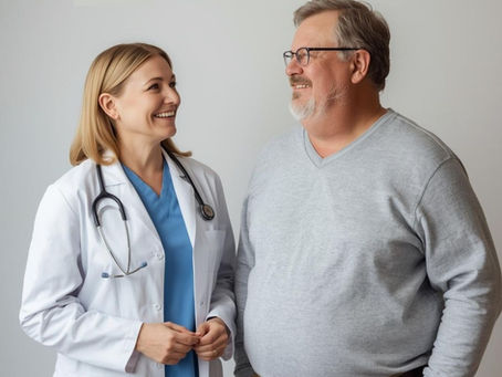 A female doctor speaking with a male patient. both lok happy and smilimg.