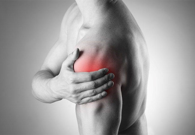 Photo of someone experiencing shoulder pain and highlighted red in the shoulder area