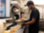 A chef pours the potato and chickpea mixture for gol guppa to-go orders. Photo by Desi Defined.