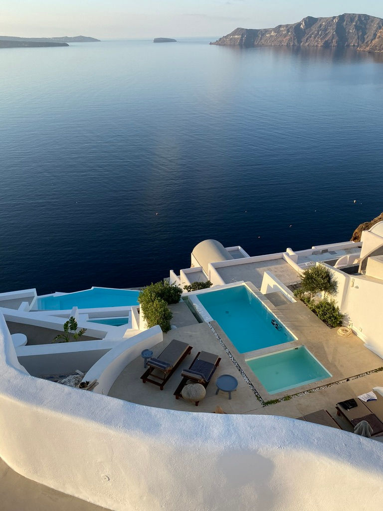 Terraced into the volcanic cliffs, this serene poolscape reflects Santorini’s timeless harmony between architecture and sea.
