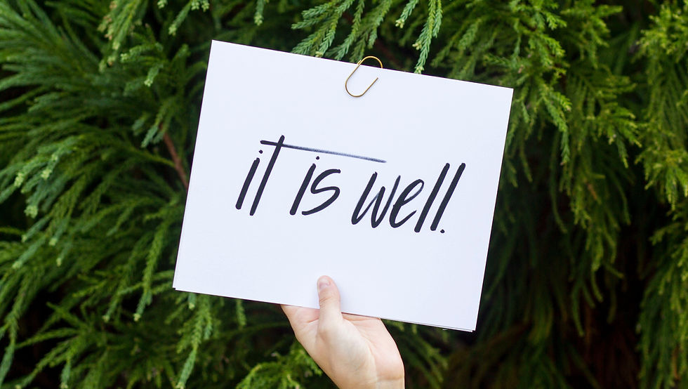 Hand holding index card with words, "it is well."