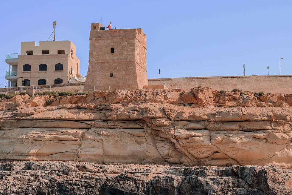 Stone watch tower and adjacent building atop rugged cliffs