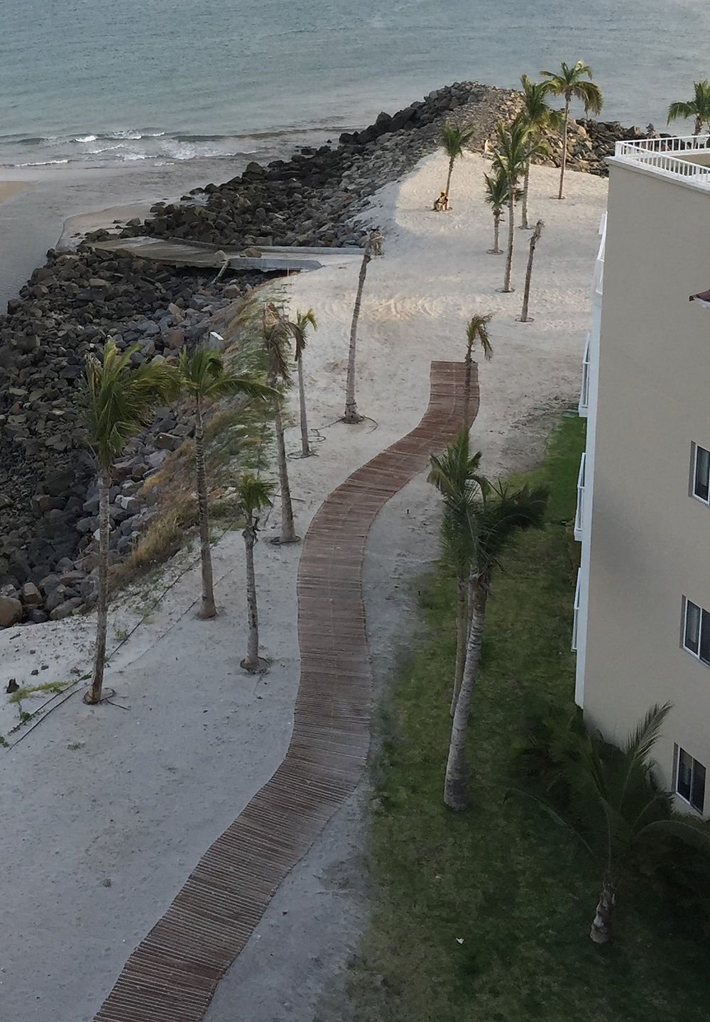 Winding Roll-Out boardwalk path on sandy beach