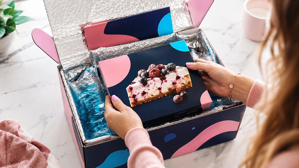 Hands unboxing a frozen food influencer mailer package with insulated cold-chain packaging on a kitchen countertop