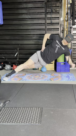 Man doing side planks with a Bodytorc suspension trainer