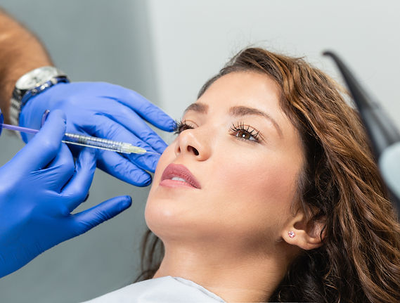 Woman getting filler injection into cheek