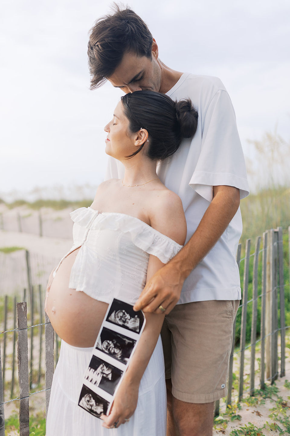 ender moment of mother holding belly with serene expression, editorial luxury maternity portrait