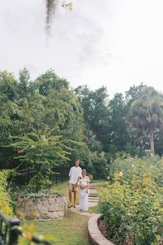 Expectant mother holding partner’s hand in elegant editorial maternity session in Florida