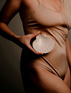 female body holding a shell
