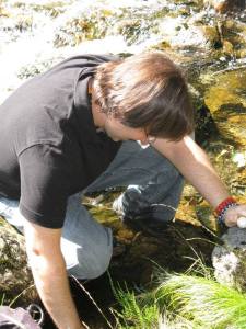 Looking for gems by someone who taught me to look for the gems ... Christopher playing in Merlin's pool at the base of Dinas Emrys in Wales on the Temple's Wild Magick of Wales pilgrimage.