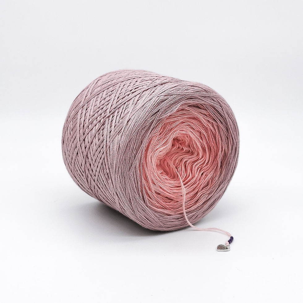 Peach and pink yarn cake on a white background