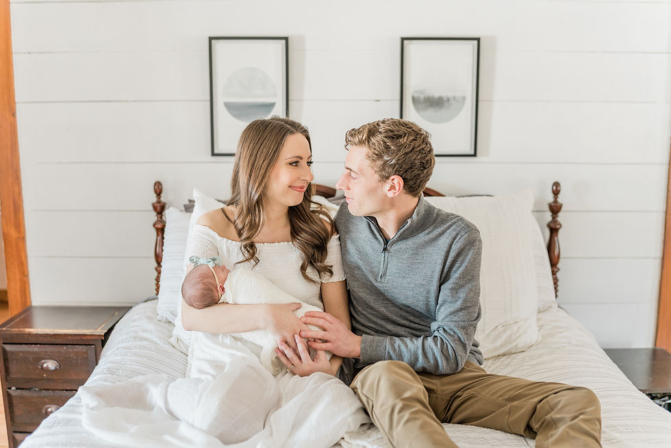 mother and father looking at each other on bed
