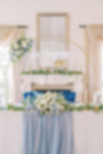 wedding head table with gold arch and neon name sign