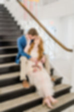 couple sitting on stairs in art museum