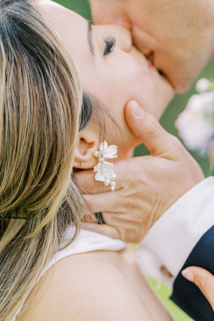 Man holding brides face and kissing her