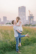 couple in field with city view