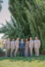 groom in navy blue suit with groomsmen in grey suits