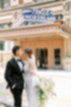 bride and groom kiss in front of hotel northland