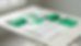 Top-down view of aligned workbooks and loose assessment pages on a clean table.