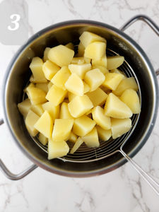 Once the potatoes are tender, drain them in a colander and return them to the pot.