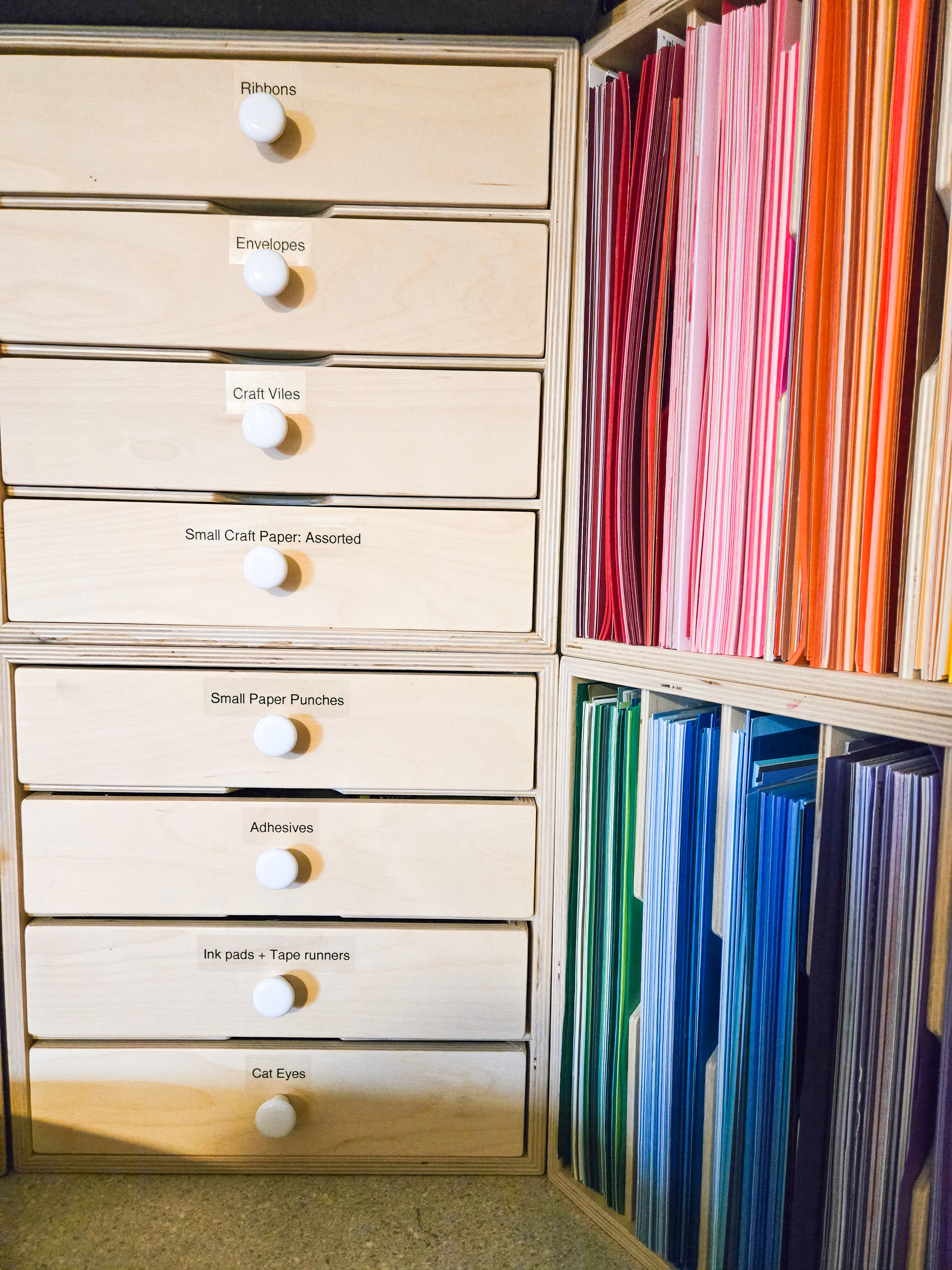 Craft supplies sorted into labeled drawers