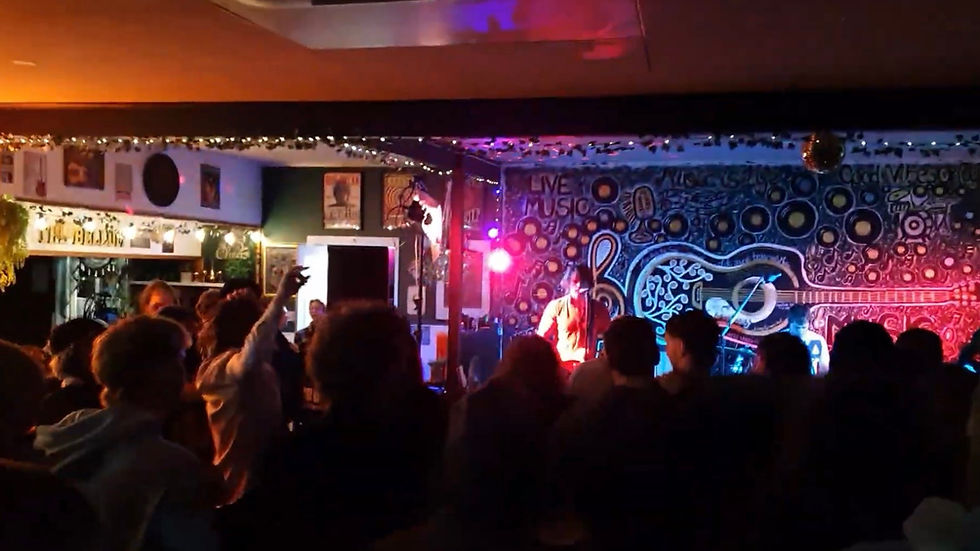 Close-up view of hands clapping in a crowd during an Australian live music performance.