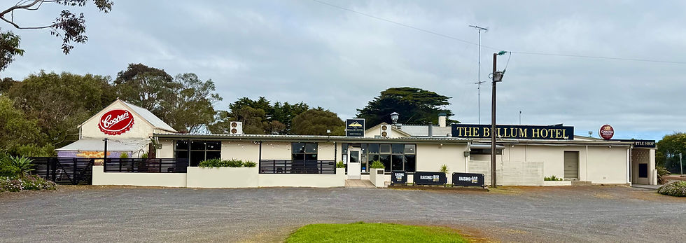 Eye-level view of a quiet country pub near Mount Schank with travellers arriving after a day exploring the Limestone Coast.