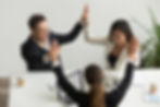 excited-multiracial-team-holding-hands-giving-high-five-celebrating-success.jpg
