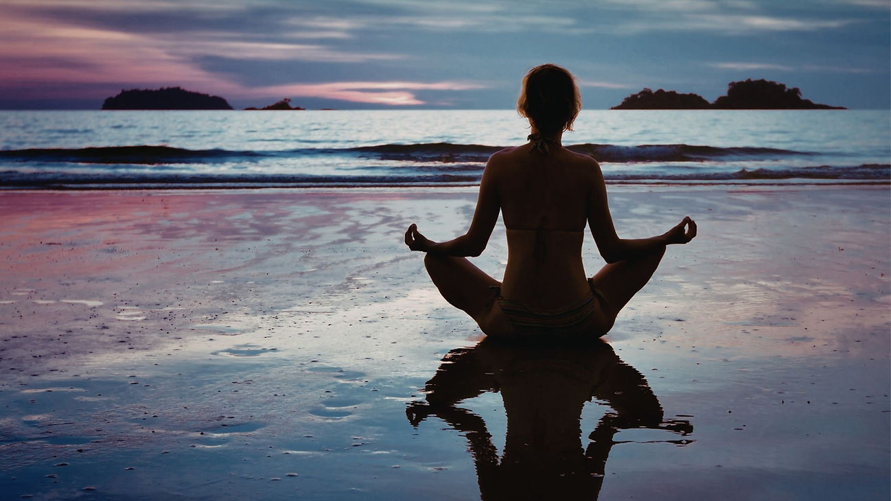 Woman Meditating on the beach