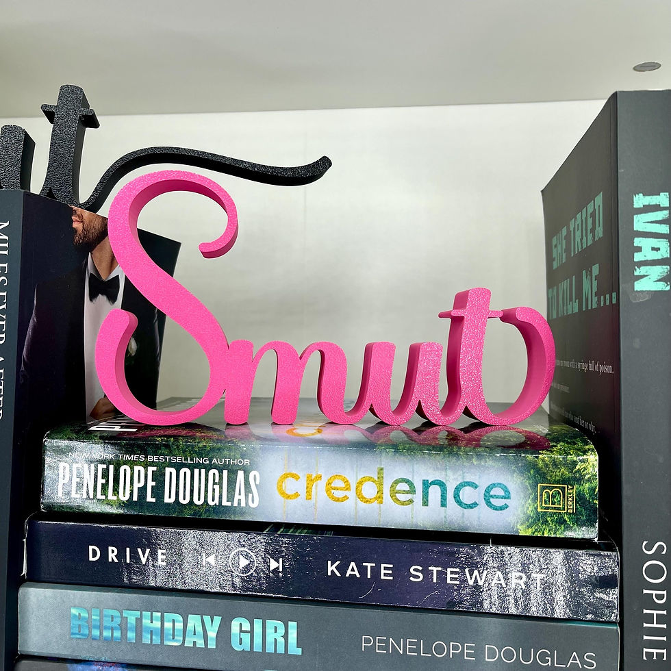 Thumbnail: Pink 'Smut' decor on book Credence. Scented Book Trope Candle – Smutty Romance