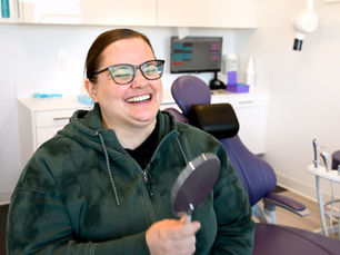 Ashley smiling after full mouth restoration at Vivid Specialized Dentistry in Edmonton