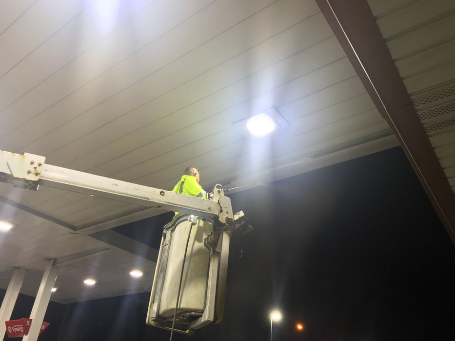 F&M Utility Group replacing gas station lighting fixtures for enhanced illumination and safety.