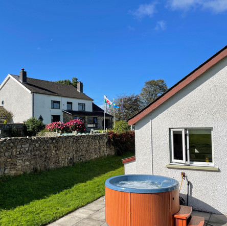 Exterior of Chestnut Cottage with hot tub.